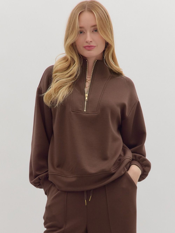 Woman wearing a brown tracksuit on a white background