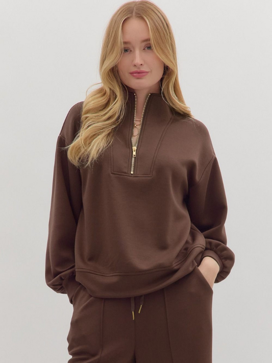 Woman wearing a brown tracksuit on a white background