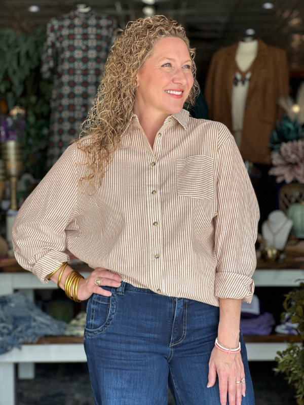 Woman wearing a striped shirt and jeans in a store setting