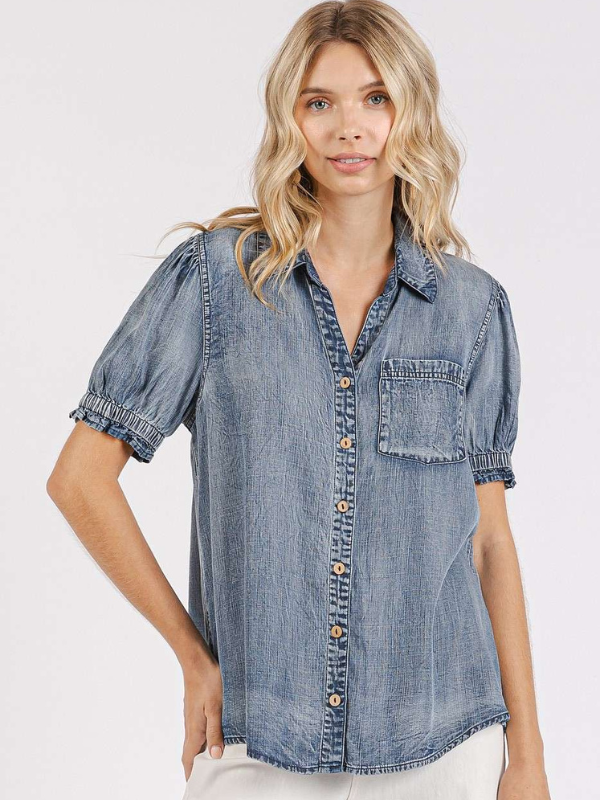 Woman wearing a denim shirt on a white background