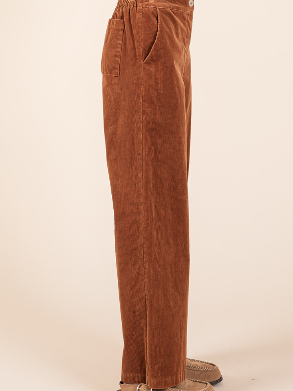 Brown corduroy pants on a beige background