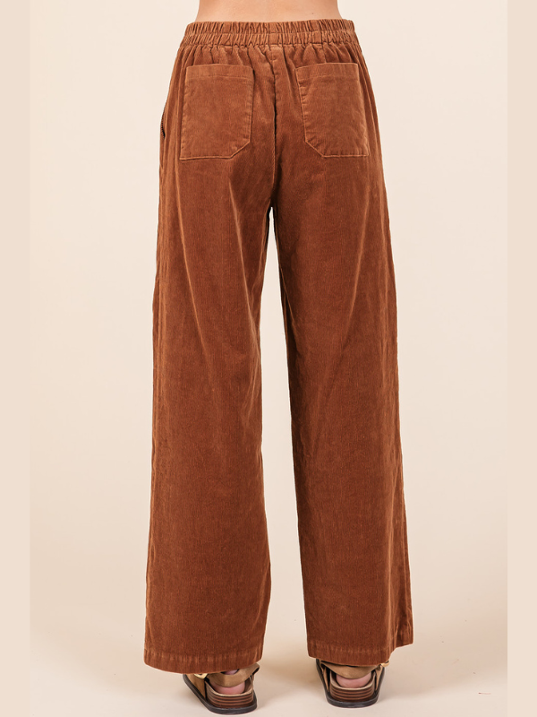 Brown corduroy pants on a beige background