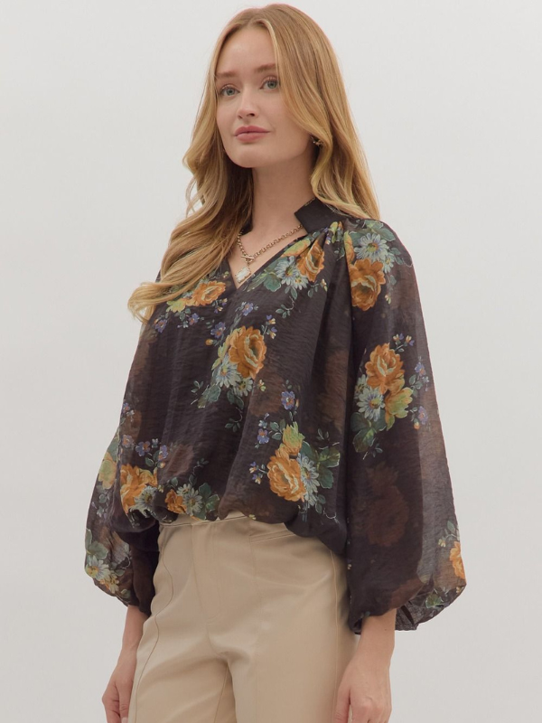 Woman wearing a floral blouse with a plain background