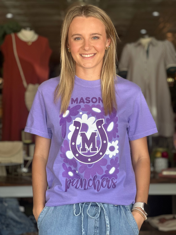 Person wearing a purple t-shirt with 'Mason Punchers' design in a store setting