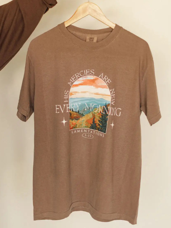 brown tee shirt being held