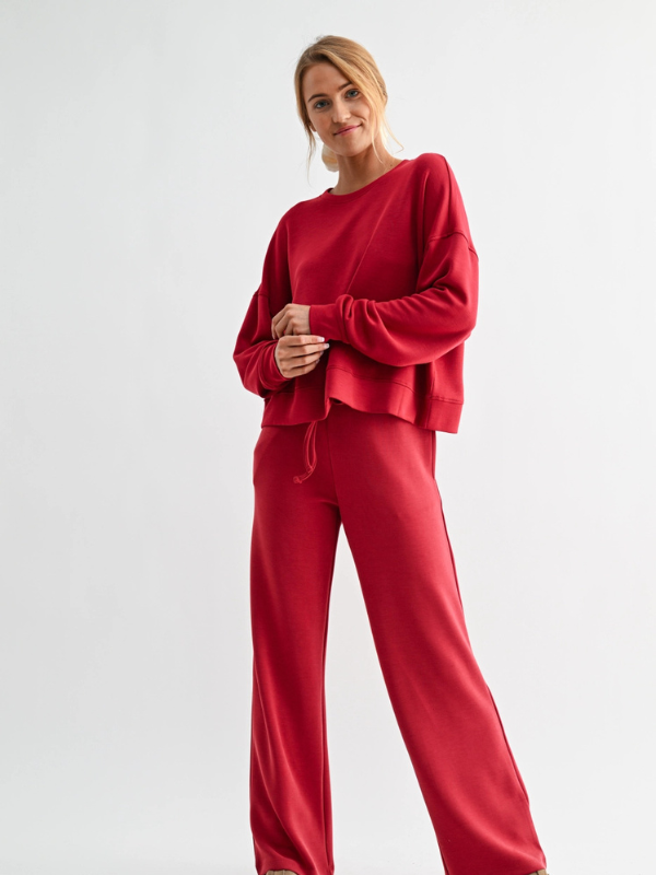 Woman wearing a red outfit on a white background