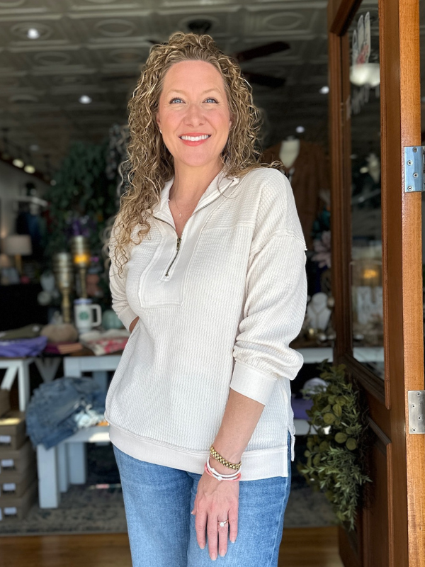 Woman standing in a store with a neutral expression