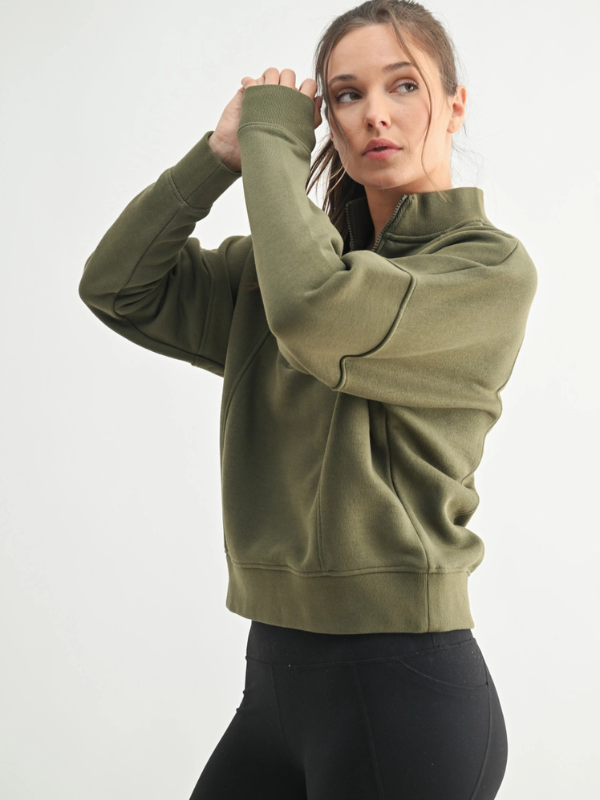 Woman wearing a green hoodie on a white background