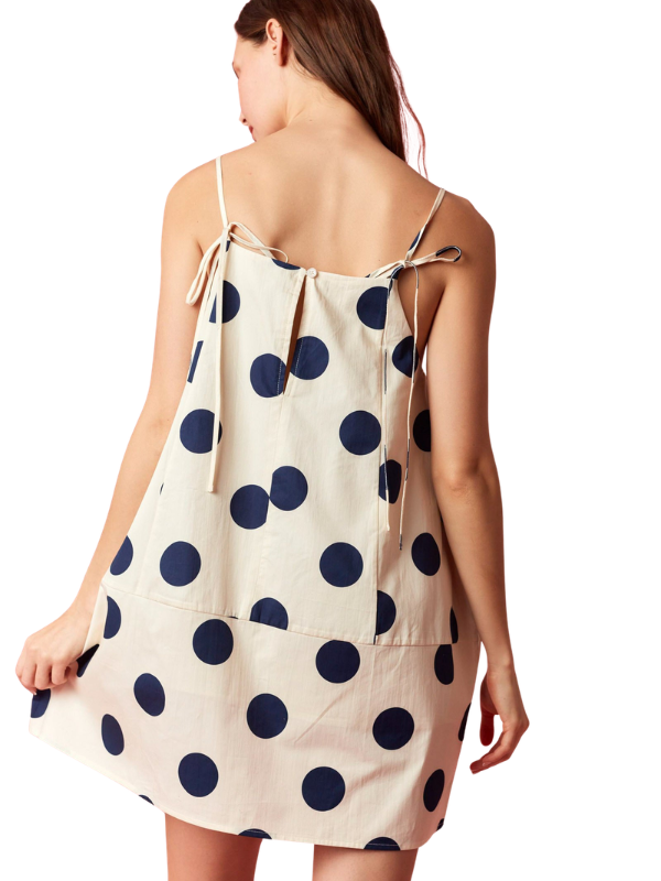 Woman wearing a polka dot dress on a white background