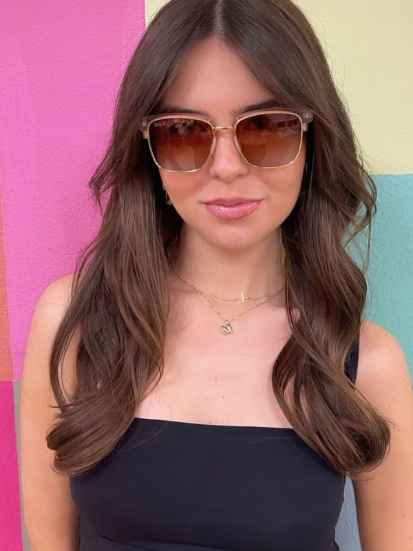 Woman wearing sunglasses with a colorful background