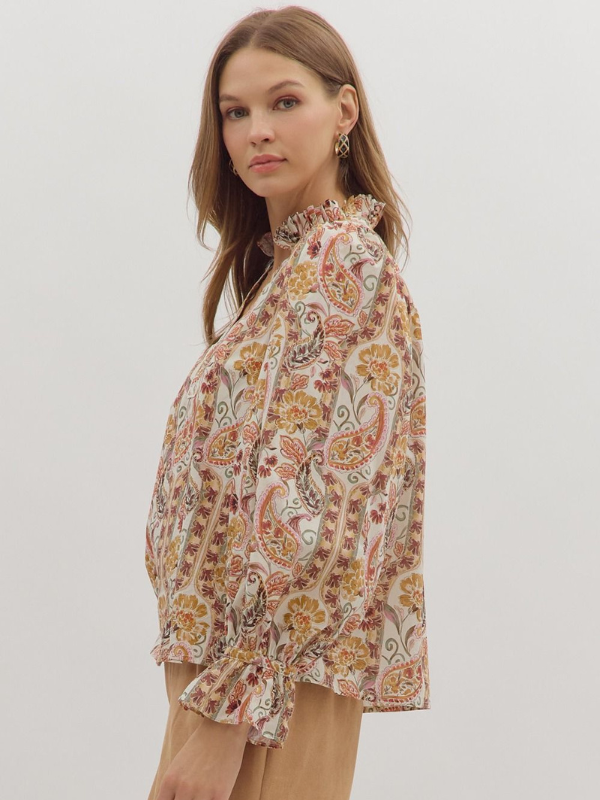 Woman wearing a floral blouse against a plain background