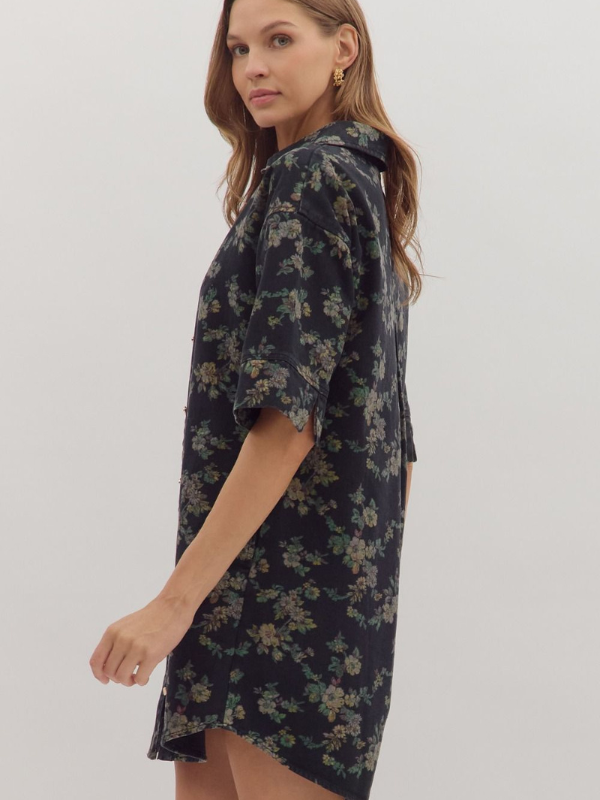 Woman wearing a dark floral dress on a white background