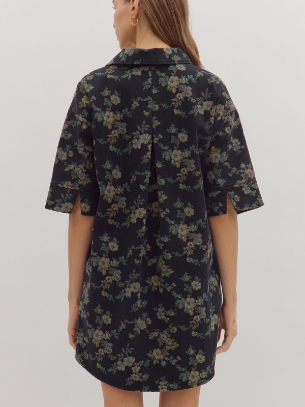 Woman wearing a dark floral dress against a white background