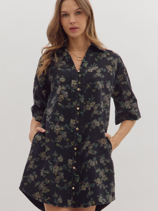 Woman wearing a black floral dress against a white background