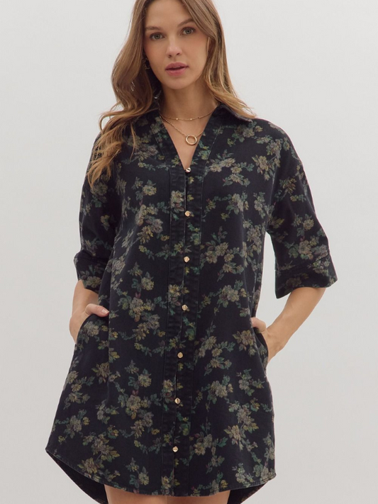 Woman wearing a black floral dress against a white background