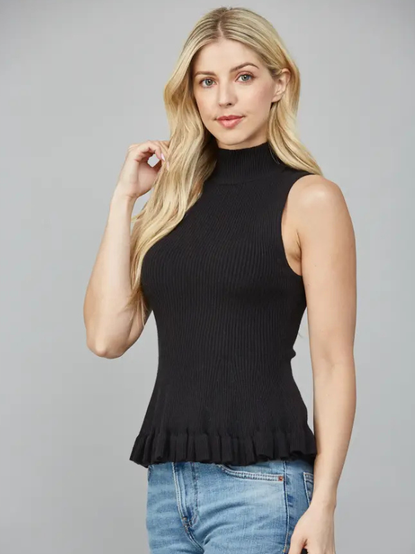 Woman wearing a black sleeveless top with ruffled hem against a gray background