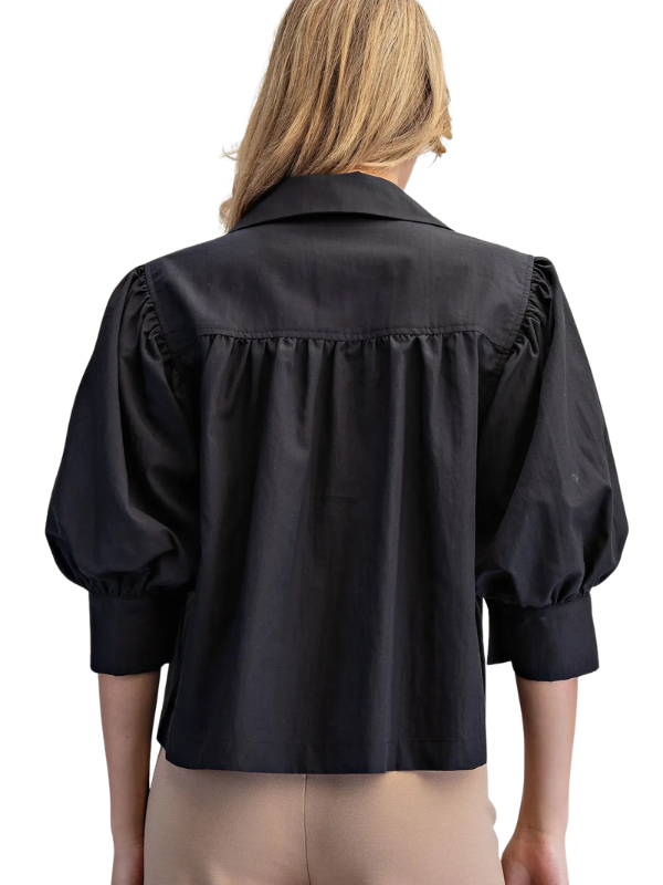 woman wearing a black puff sleeve top
