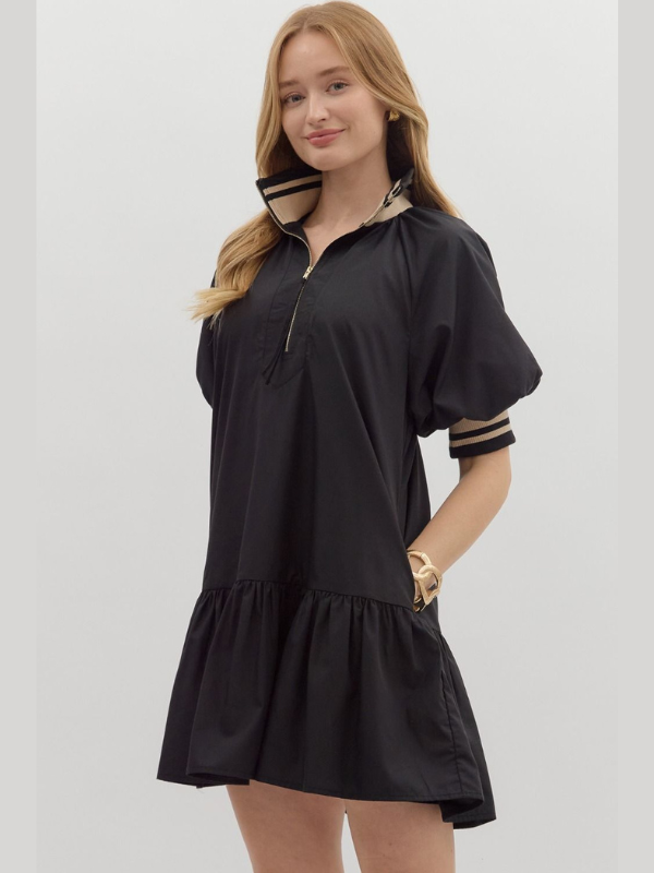 Woman wearing a black dress with puff sleeves on a white background