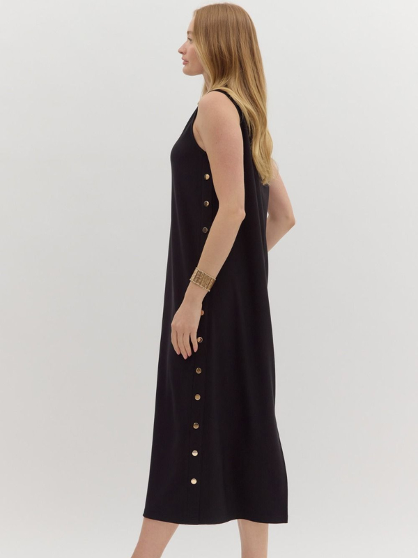 Woman wearing a black sleeveless dress with buttons on a white background