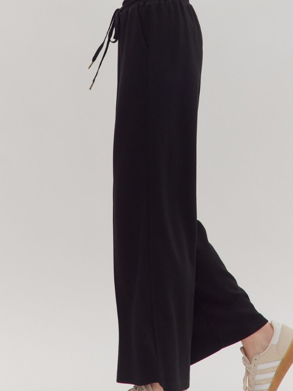 Black wide-leg pants on a white background