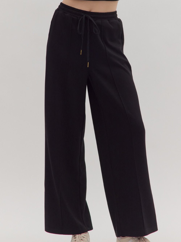 Black wide-leg pants on a plain background