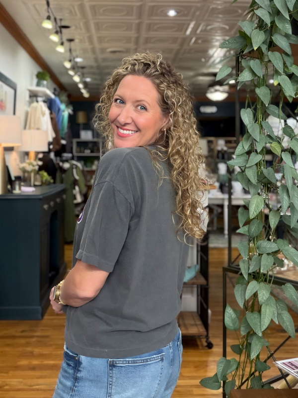 woman wearing a boxy grey tee that says Mason