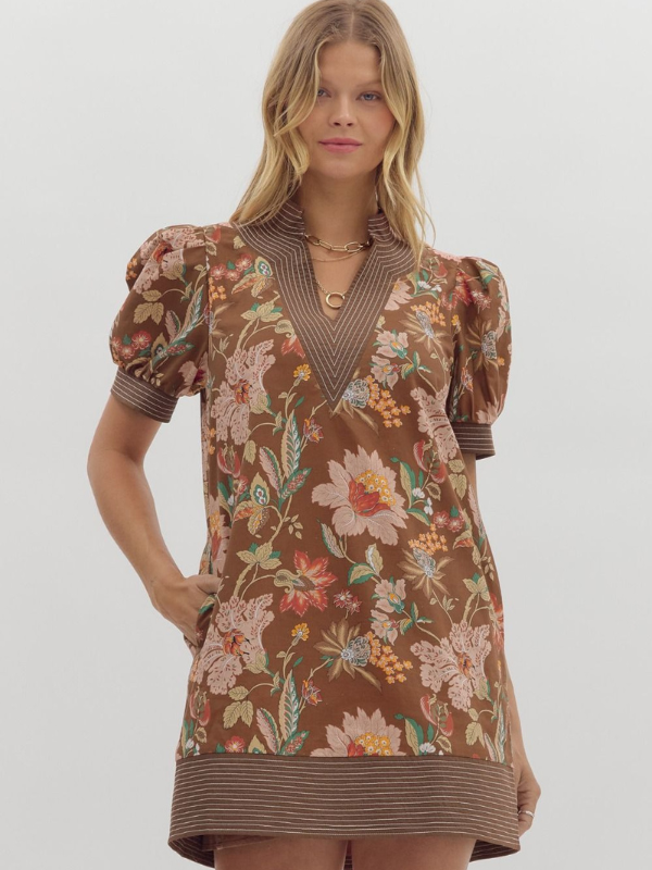 Woman wearing a floral dress with puff sleeves on a white background