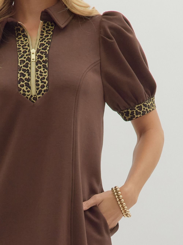 Brown blouse with leopard print accents on a plain background