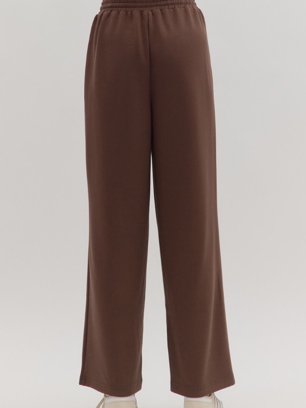Brown wide-leg pants on a light gray background