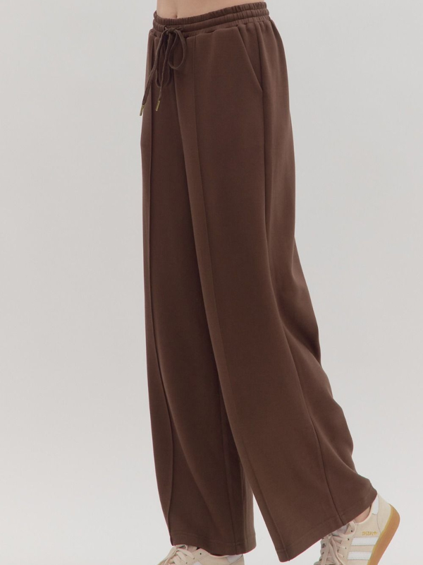 Brown wide-leg pants on a plain background