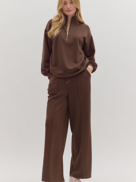 Woman wearing a brown outfit on a white background
