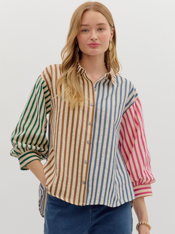 Woman wearing a multicolored striped shirt with a white background