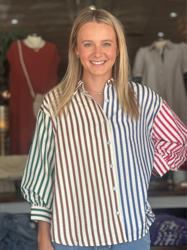 Woman wearing a striped shirt in a clothing store setting