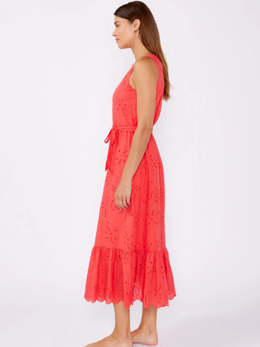 Woman wearing a coral dress on a white background