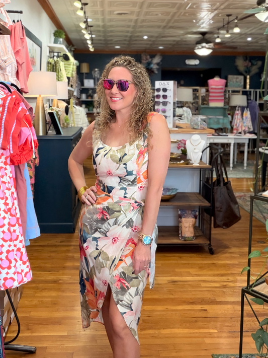 Woman in a floral dress standing in a clothing store