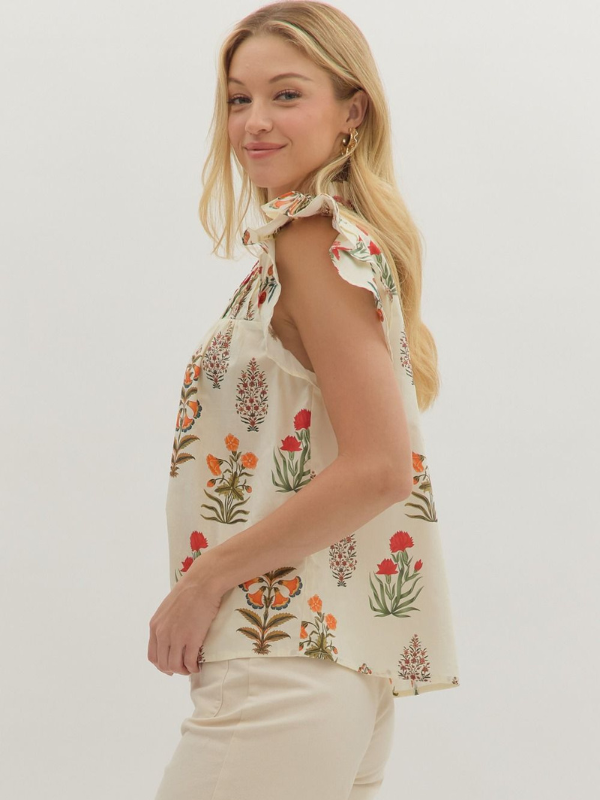 Woman wearing a floral sleeveless top against a white background