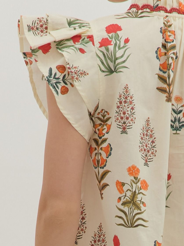 Floral patterned fabric with red, green, and orange colors on a white background