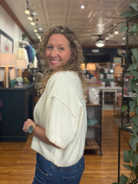 woman wearing a cream blanket stitched sweater
