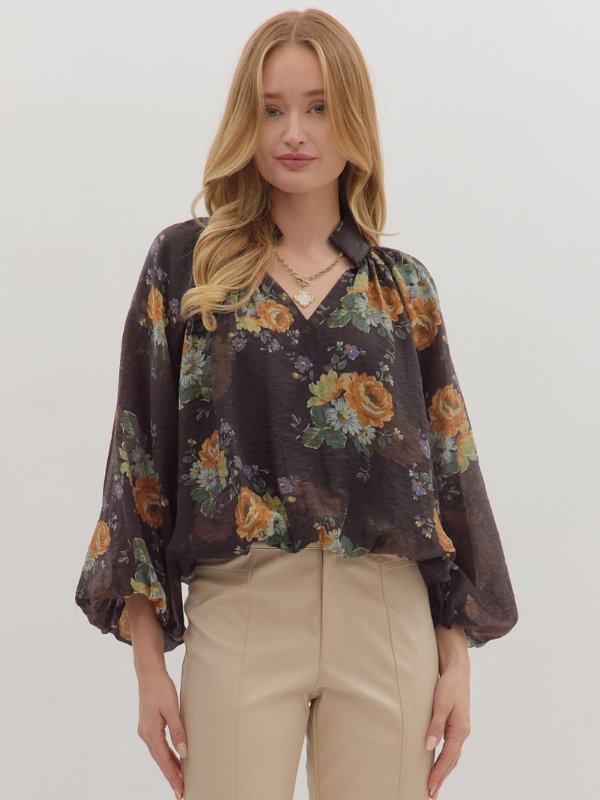 Woman wearing a floral blouse with a plain background