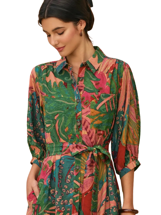 Woman wearing a colorful patterned dress on a white background