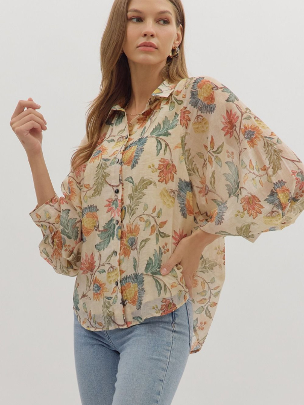 Woman wearing a floral blouse with a plain background