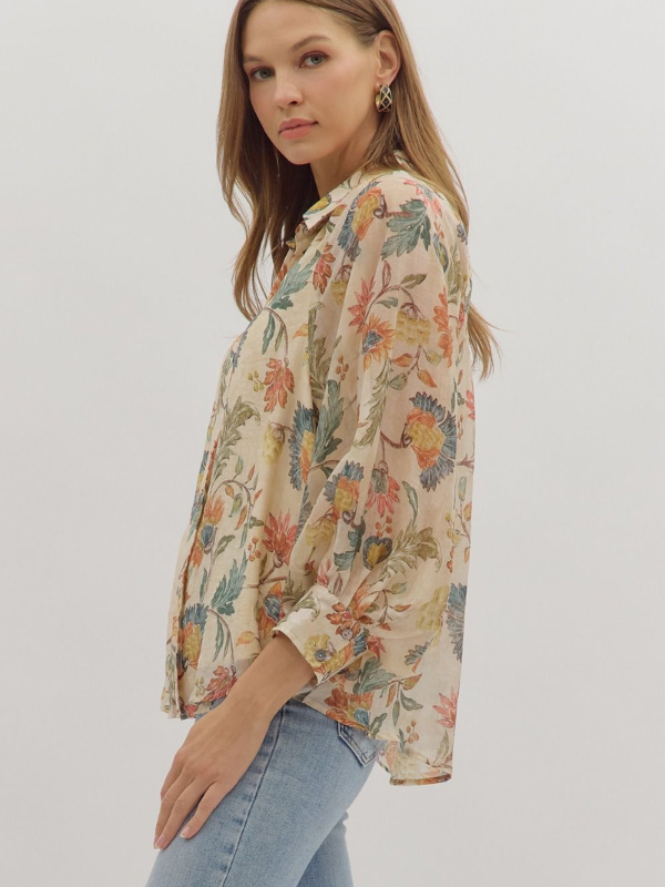 Woman wearing a floral blouse with a plain background