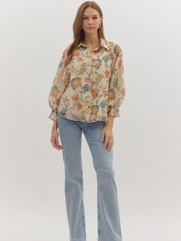 Woman wearing a floral blouse and jeans on a white background