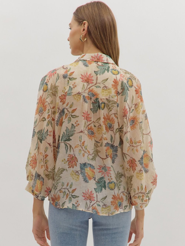 Woman wearing a floral blouse with a plain background