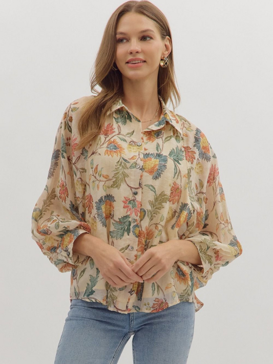 Woman wearing a floral blouse with a plain background