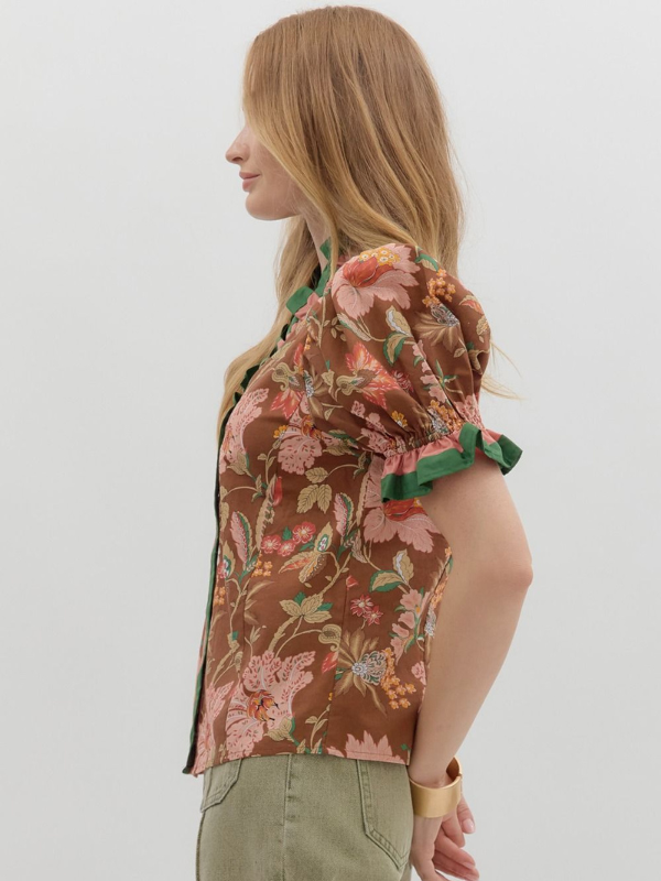 Woman wearing a floral jacket with a white background