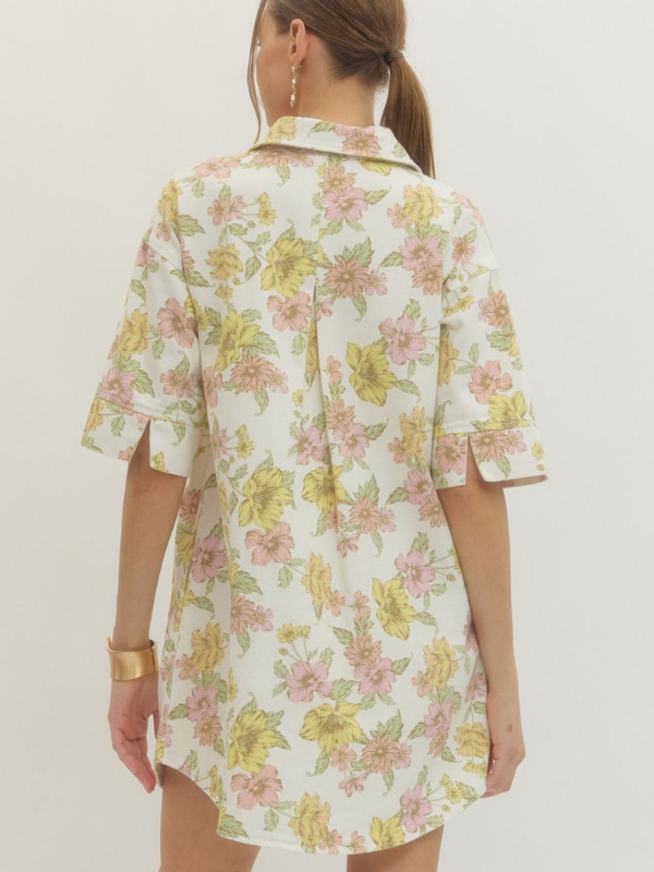 Woman wearing a floral dress with a plain background