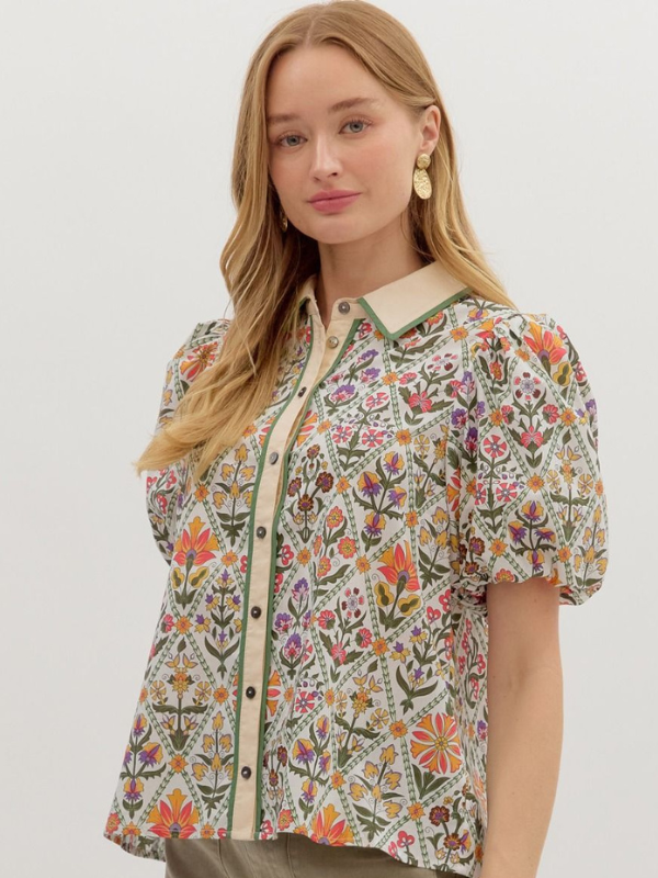Woman wearing a floral blouse with a white background