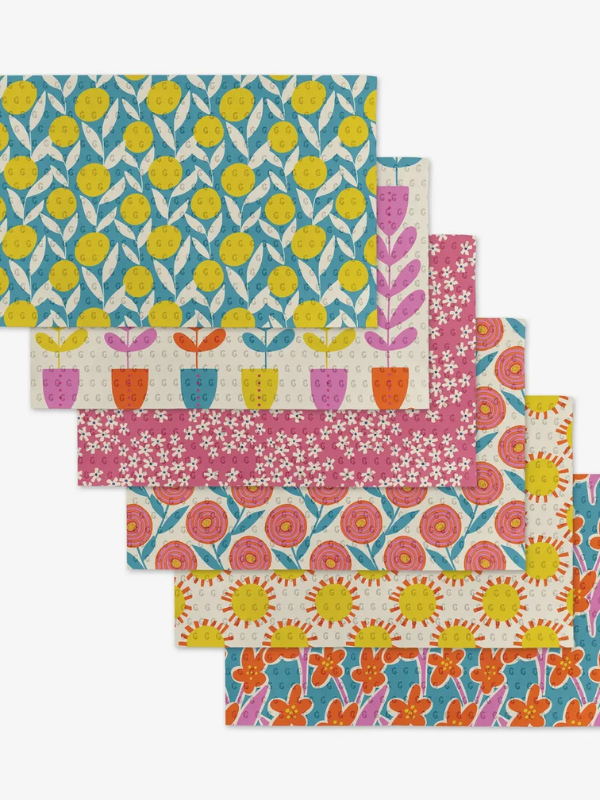 Set of colorful patterned paper sheets on a white background