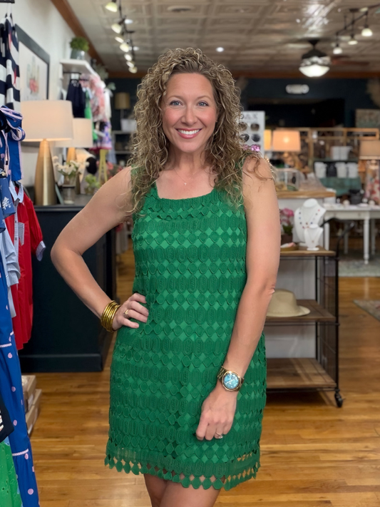 Woman wearing a green dress in a store setting
